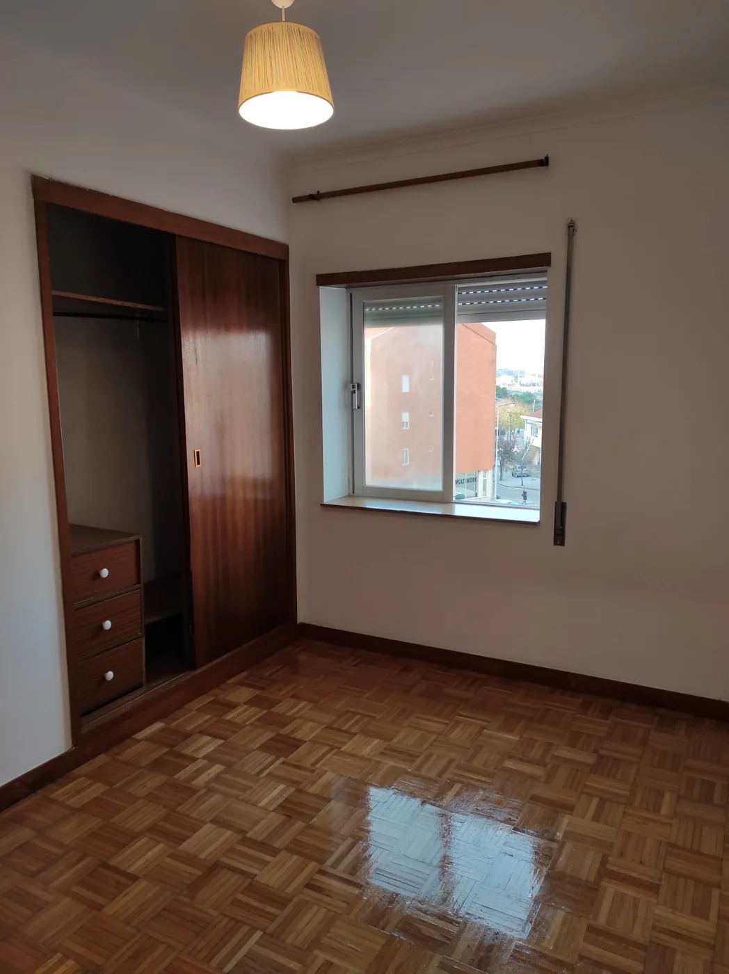Segundo quarto do T3 com roupeiro embutido, cómoda e soalho em tacos
