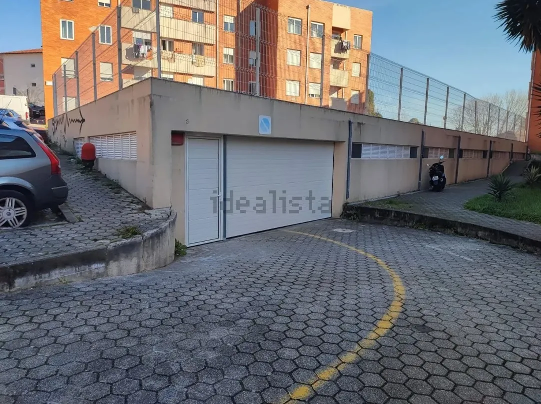 Portão da garagem, numa fila de boxes junto ao estacionamento do bairro